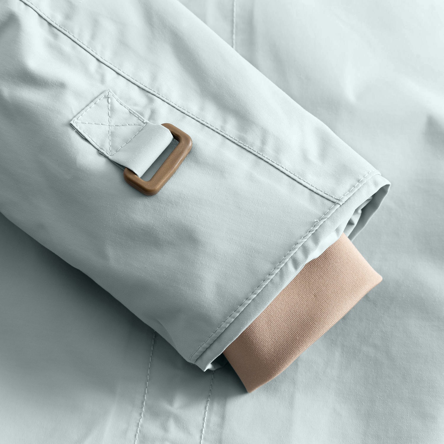 Detail of the MATWALLY fleece lined winter jacket sleeve in pale mint green, showing the metal D-ring with fabric tab for snow cuff adjustment and the beige ribbed inner cuff with thumb opening visible at the hem.