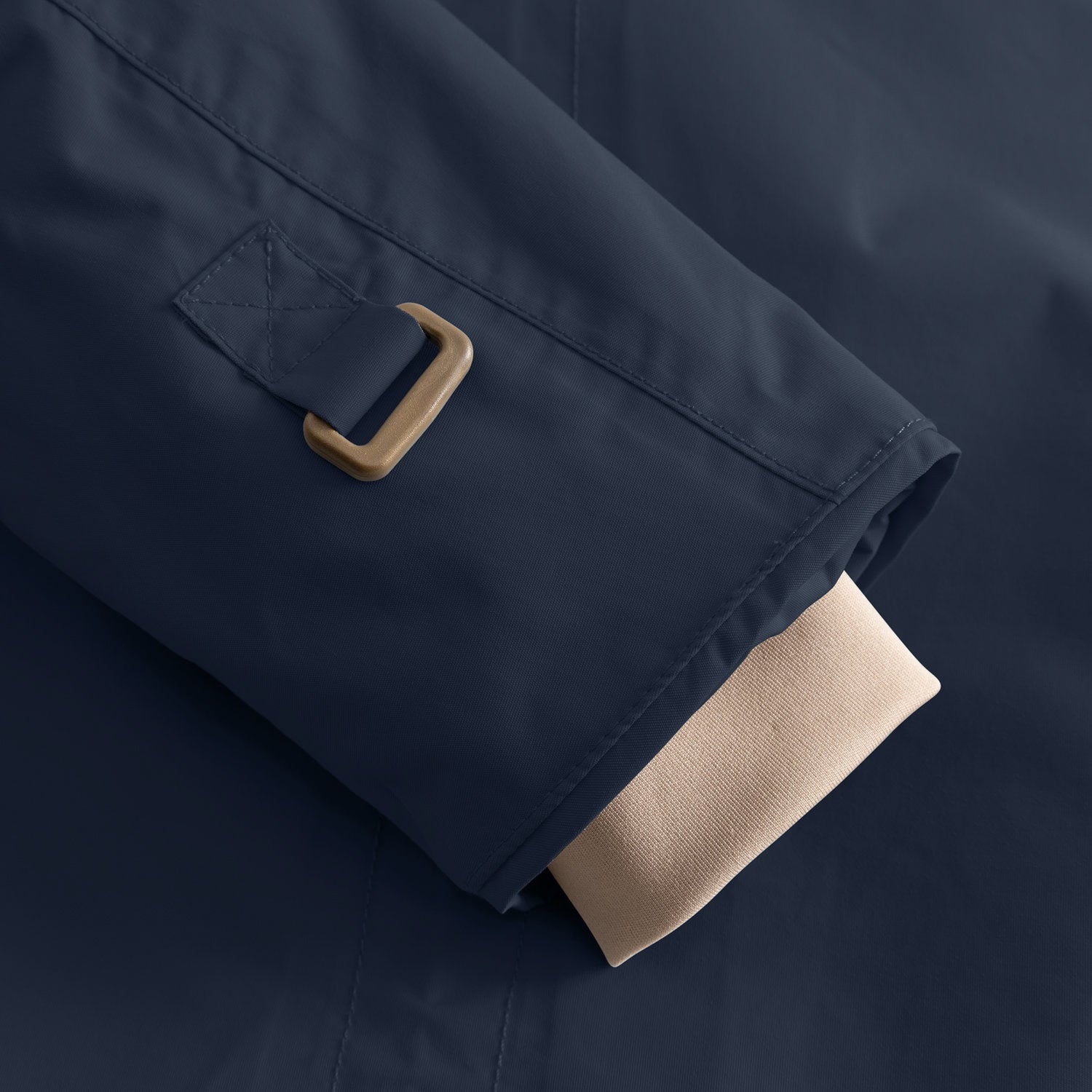 Detail of the MATWALLY fleece lined winter jacket sleeve in navy blue, showing the metal D-ring with fabric tab for snow cuff adjustment and the beige ribbed inner cuff with thumb opening visible at the hem.