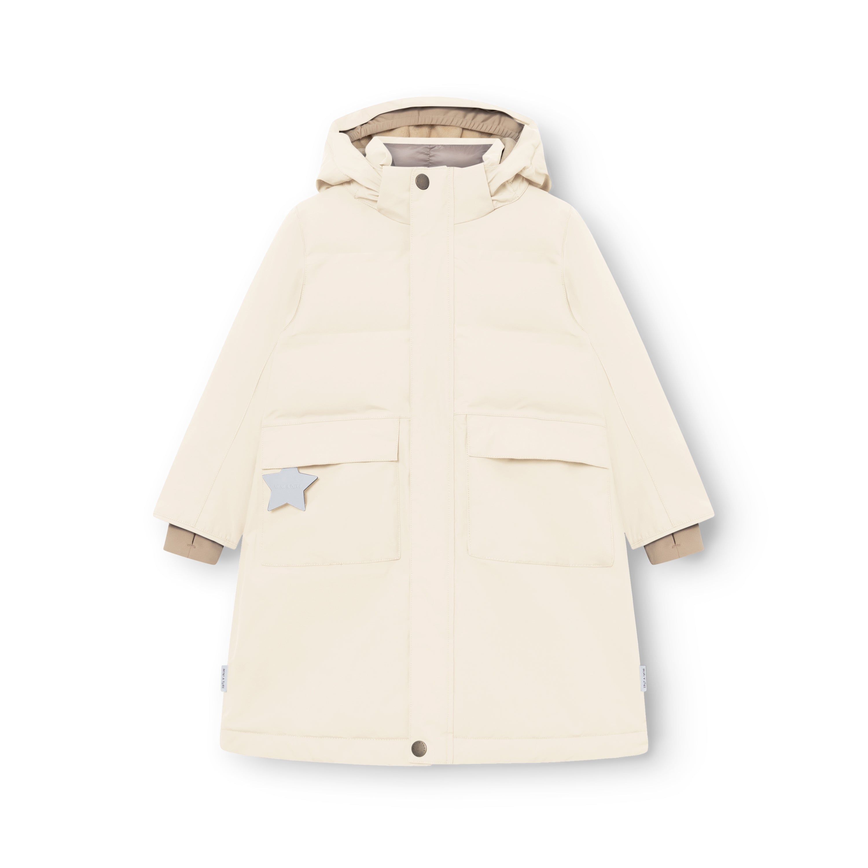 MATVENCASIA winter jacket in cream, laid flat to show the extended length, detachable hood with snap-button fastening, front patch pockets with invisible magnetic closures, reflective star detail on the right pocket, and beige cuff lining visible at the wrists.