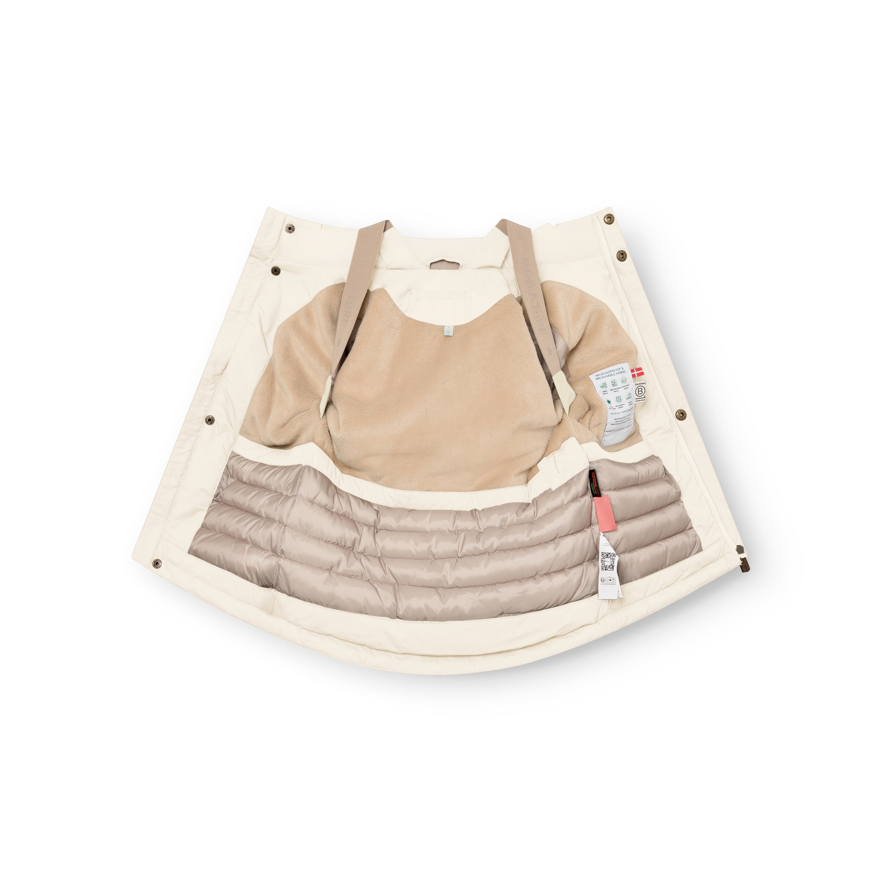 Cream MATKASTORIO fleece lined winter jacket laid flat with the interior fully visible, showing beige fleece lining across the upper body and hood, beige adjustable suspenders crossing the chest, cream Sorona Aura padded lower section with horizontal quilting, snap-button placket along both front edges, and product care labels attached to the inner right side.