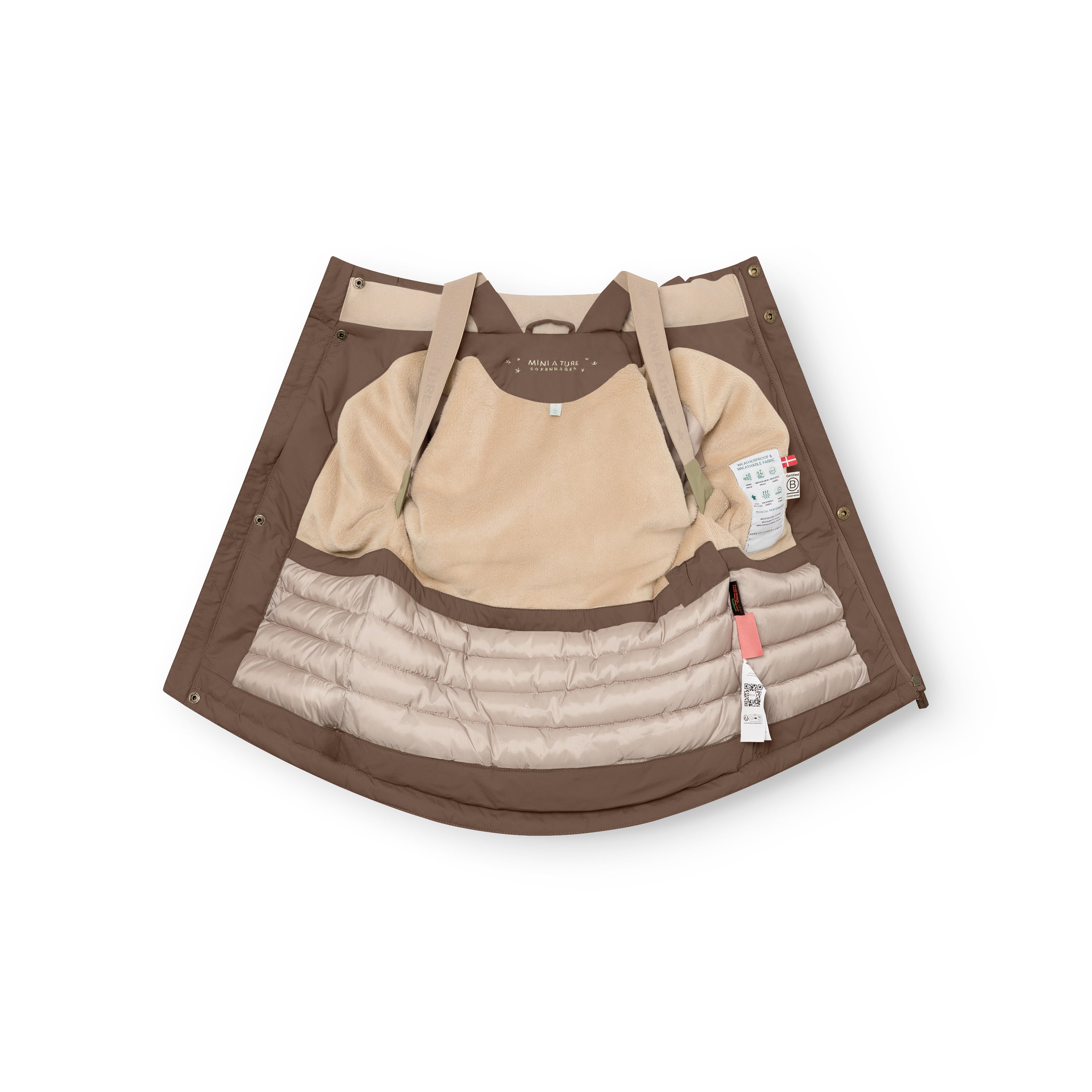 Caramel brown MATKASTORIO fleece lined winter jacket spread open to reveal the beige fleece-lined upper interior, beige adjustable suspenders, cream Sorona Aura padded lower section with horizontal quilting, snap-button placket, and product care labels visible on the inner right side.