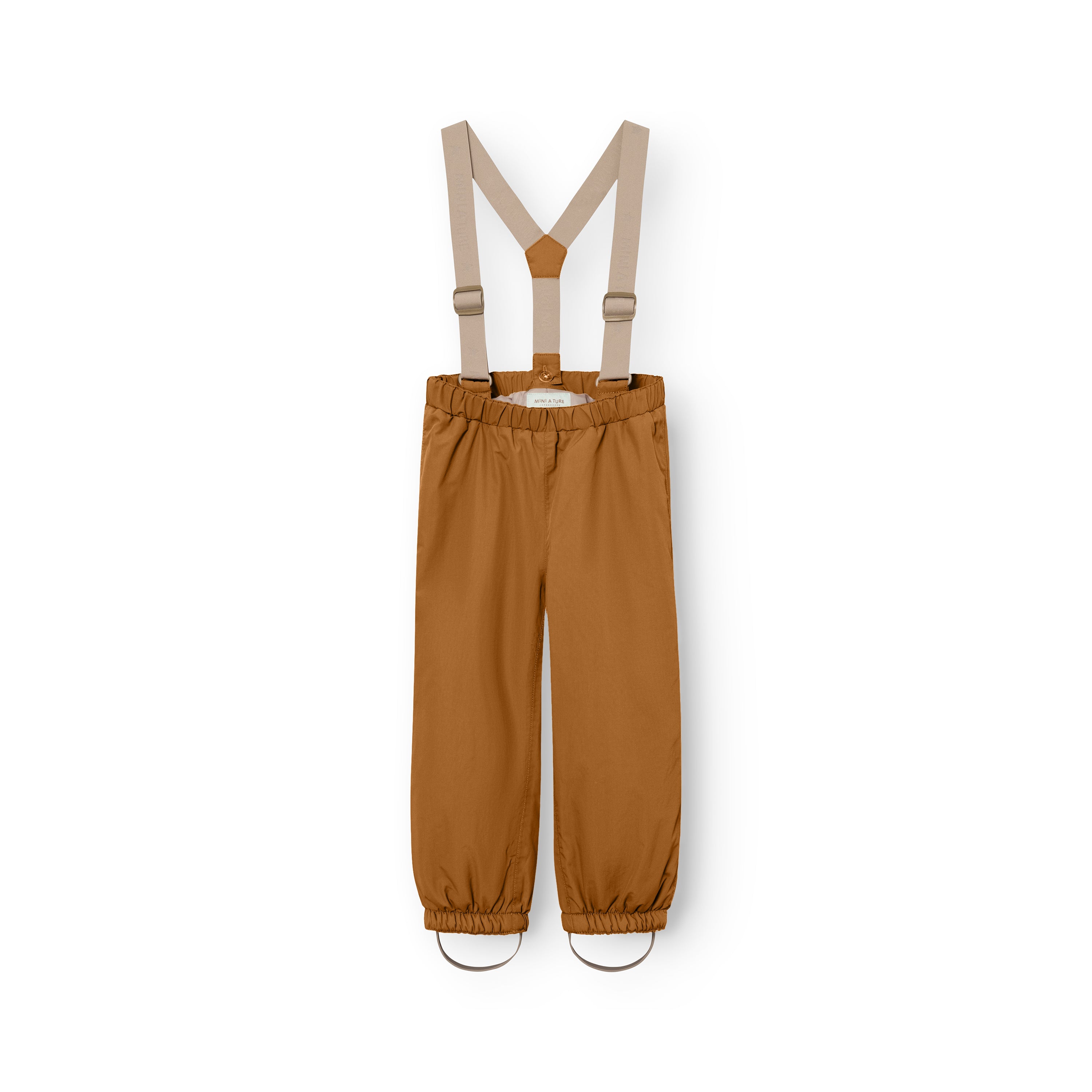 MATWILAS snow pants in golden caramel with beige adjustable cross-back braces, elasticated waistband and ankle cuffs with removable foot straps, laid flat on a white background.