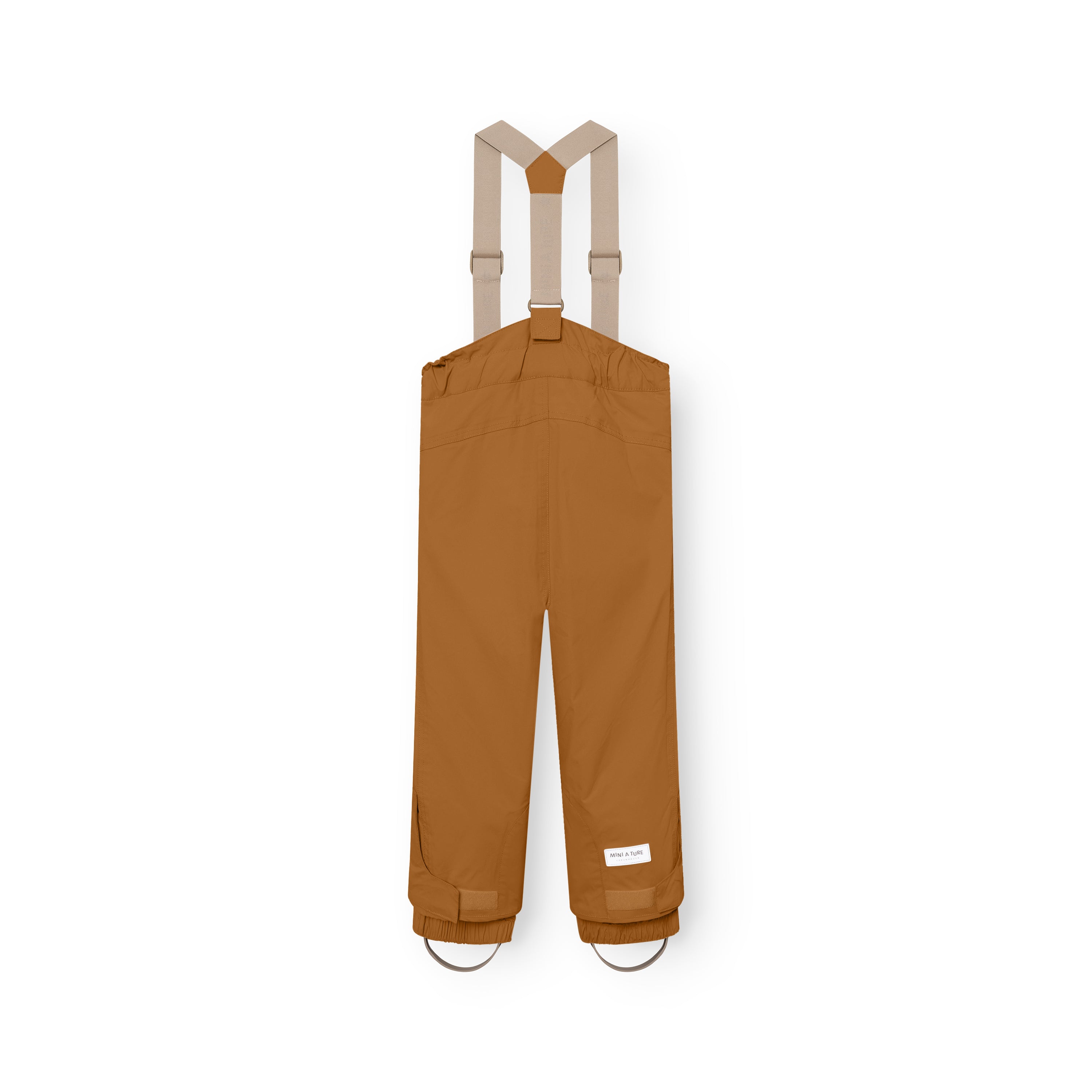 MATWITTE snow pants in caramel brown viewed from the back, showing the cross-back elastic suspender attachment, elasticated ankle cuffs with integrated foot straps, and the MINI A TURE label positioned above the reinforced lower leg.