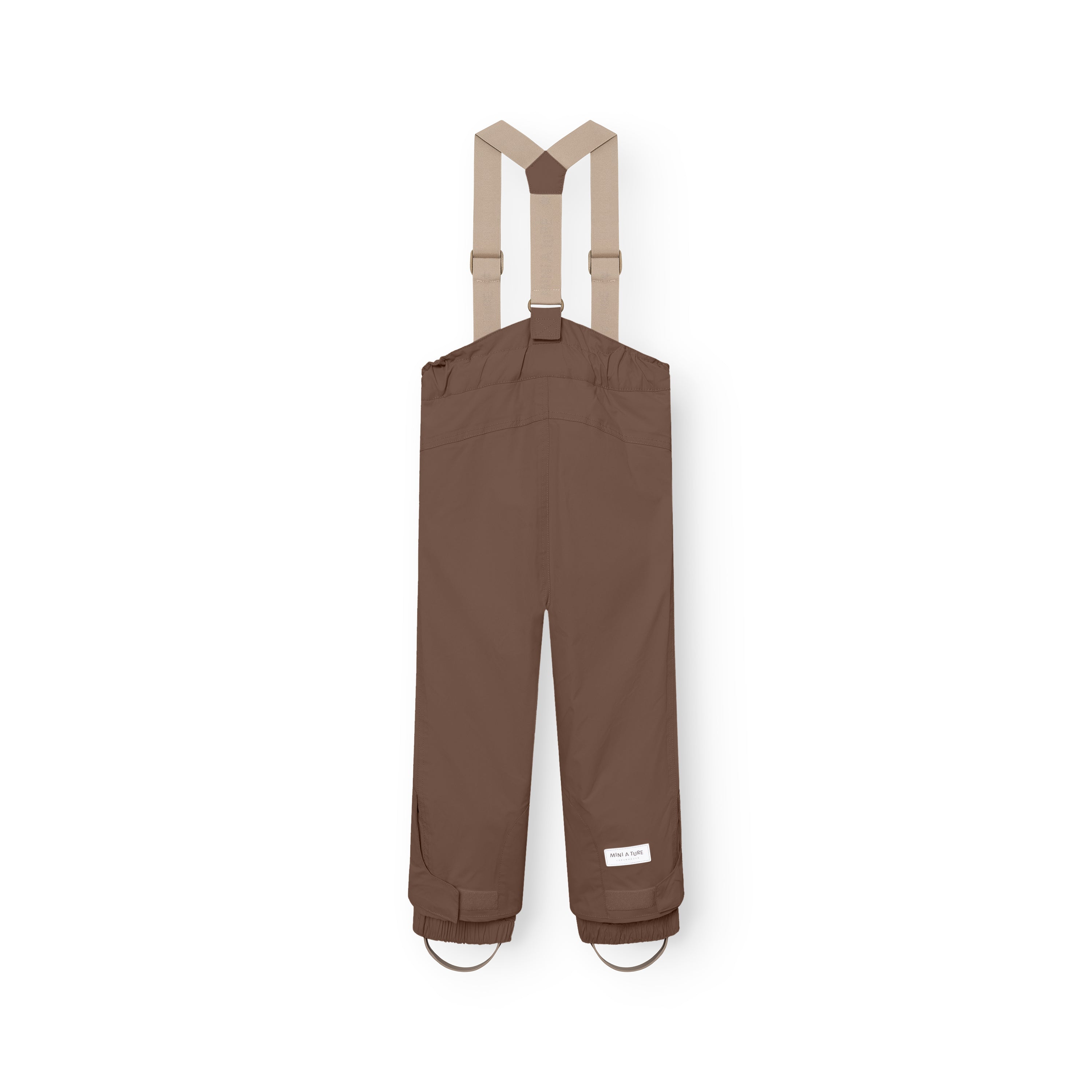 MATWITTE snow pants in brown viewed from the back, showing the cross-back elastic suspender attachment, elasticated ankle cuffs with integrated foot straps, and the MINI A TURE label positioned at the lower leg.