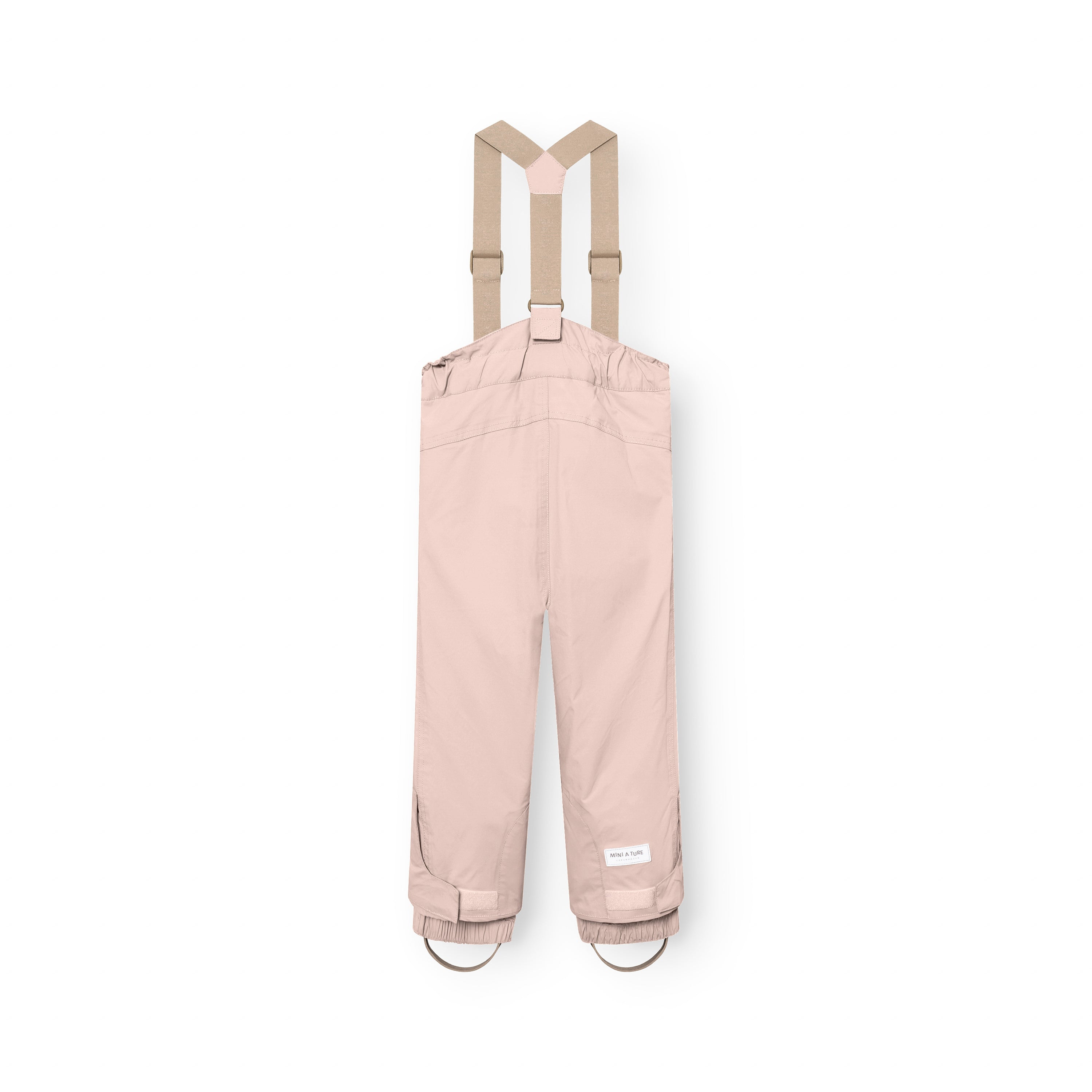 MATWITTE snow pants in soft pink viewed from the back, displaying the rear suspender attachment points, elasticated ankle cuffs with foot straps, and the MINI A TURE label positioned at the lower leg above the reinforced hem.