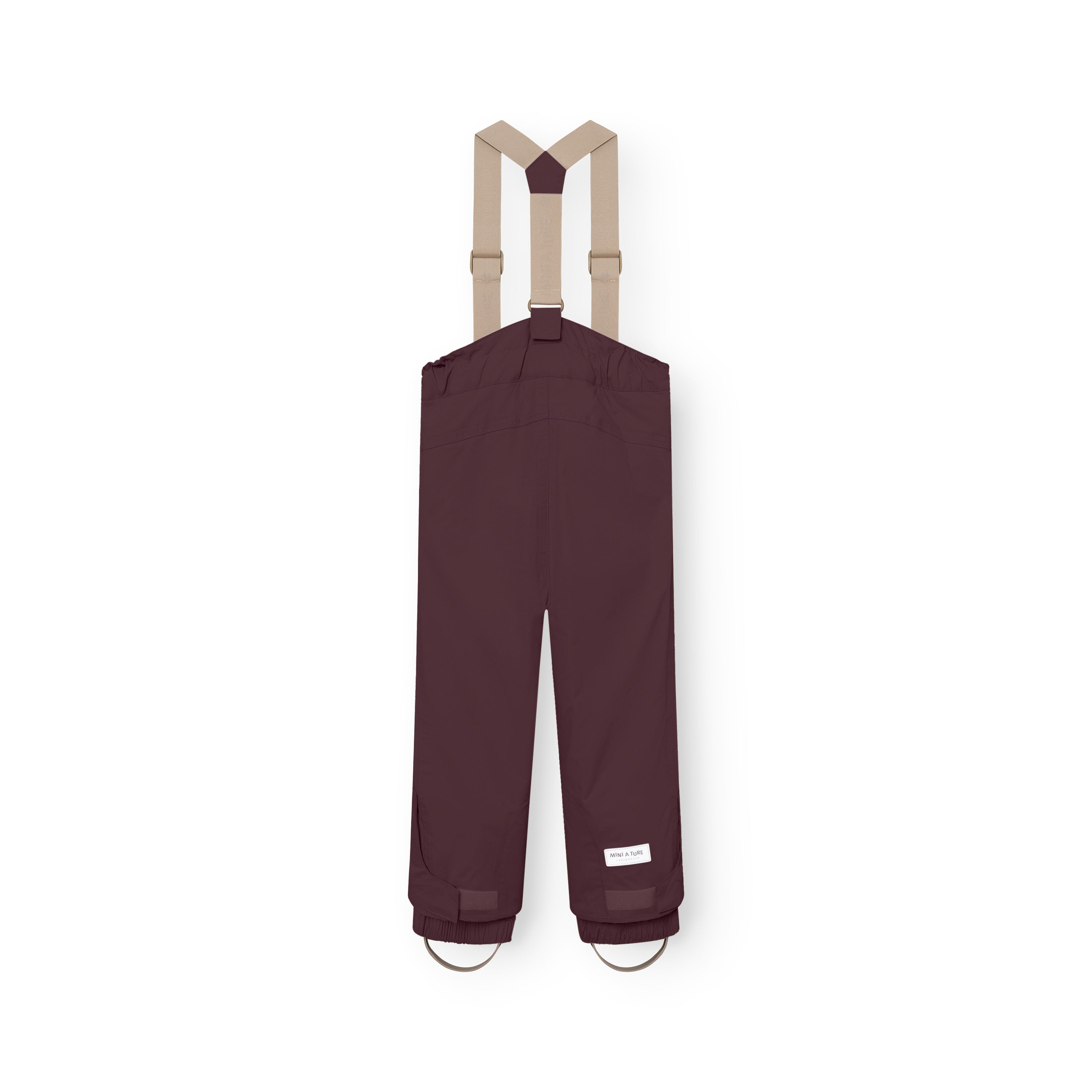 MATWITTE snow pants in deep burgundy viewed from the back, showing the cross-back elastic suspender attachment, elasticated ankle cuffs with integrated foot straps, and the MINI A TURE label positioned above the reinforced lower leg.