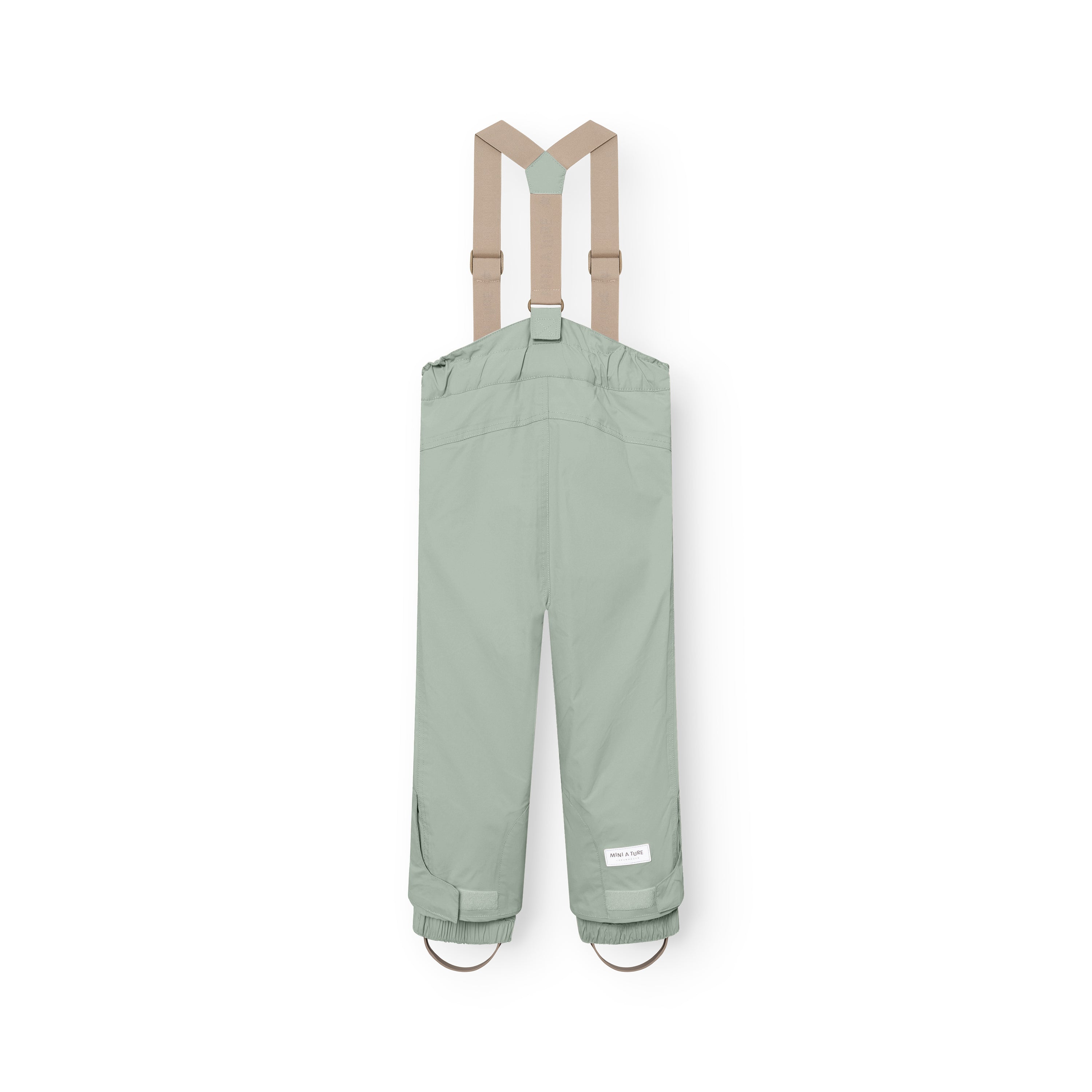 MATWITTE snow pants in sage green displayed from the back, showing the cross-back suspender attachment points, elasticated ankle cuffs with integrated foot straps, and the MINI A TURE label at the lower leg.