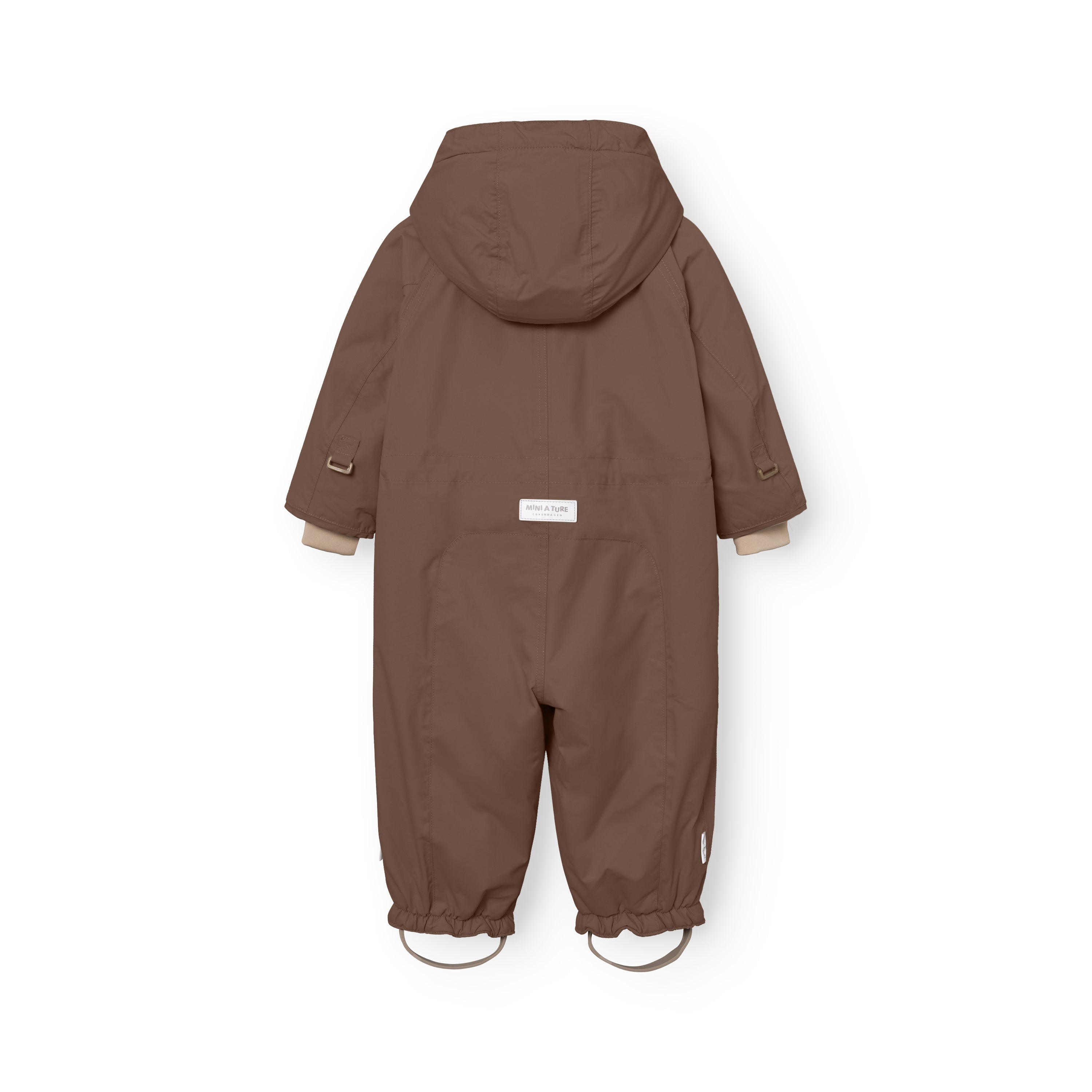 MATWISTI fleece lined snowsuit in warm brown laid flat showing the rear view with detachable hood, white MINI A TURE label at the lower back, beige ribbed cuffs and elasticated leg openings with adjustable foot straps featuring metal D-rings.