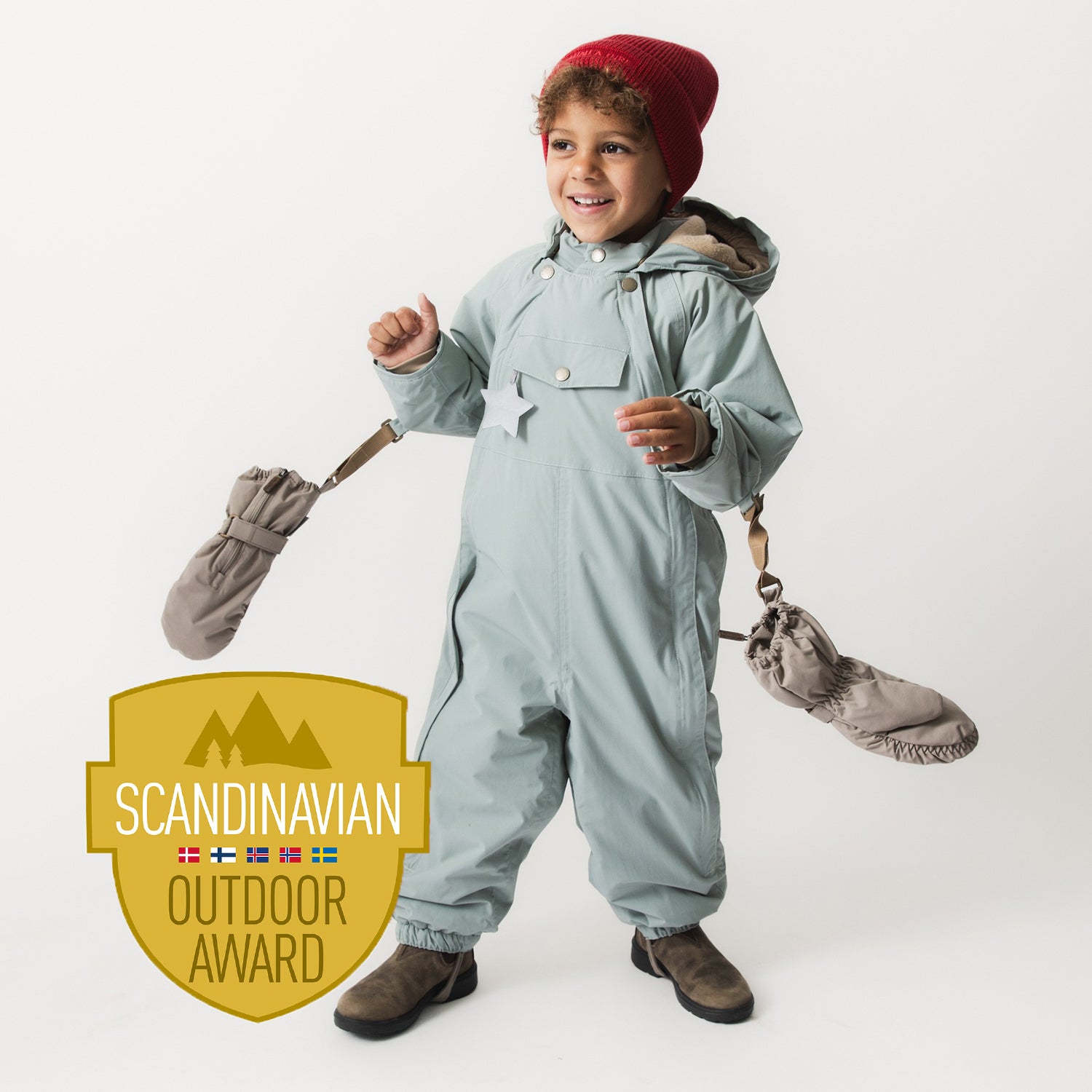 Young child wearing the MATWISTI fleece lined snowsuit in pale blue with a detachable hood, holding matching mittens and boots, styled with a burgundy knitted hat.