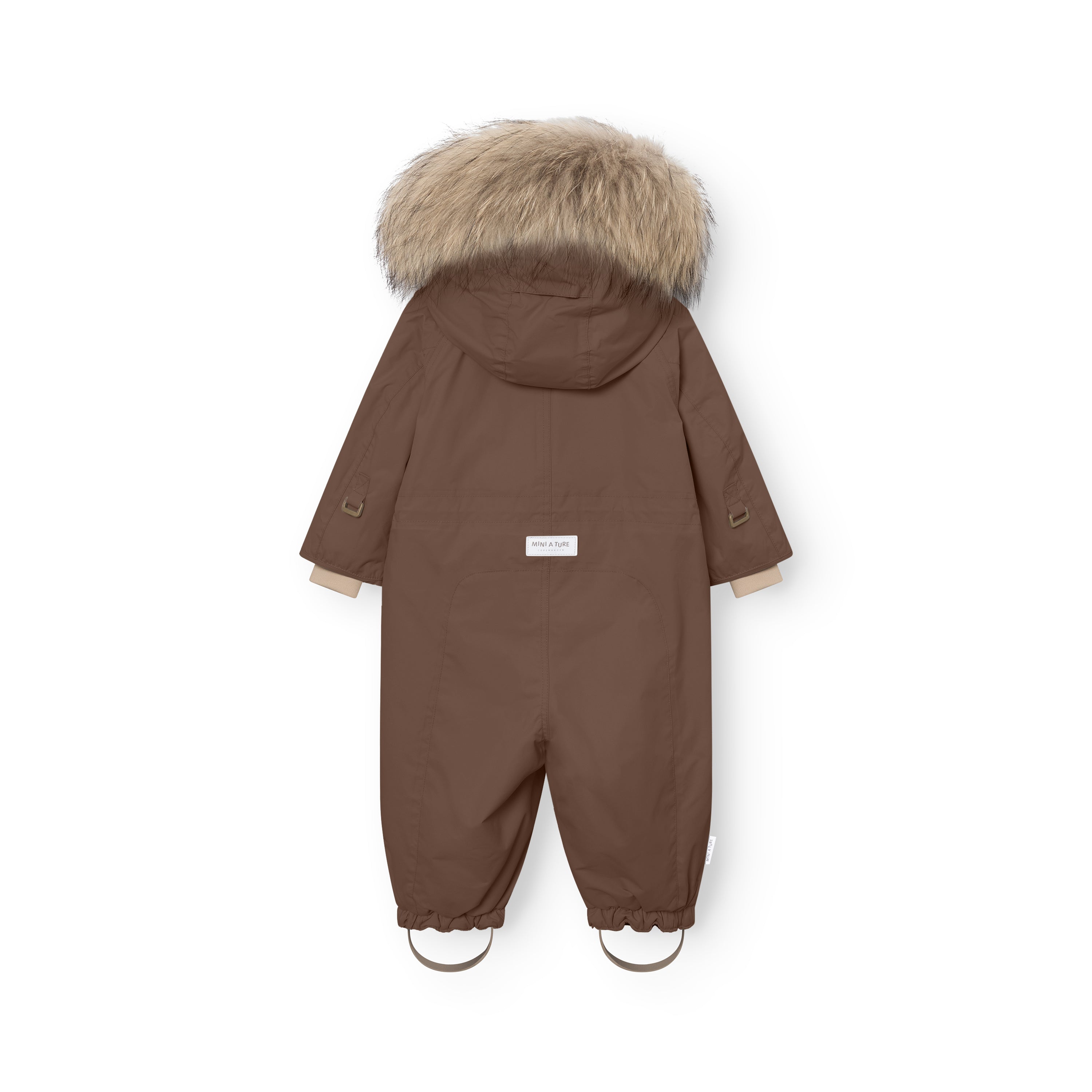 Rear view of MATWISTI fleece lined snowsuit fur in brown showing the genuine fur-trimmed hood, MINI A TURE label at the lower back, elasticated ankle cuffs with adjustable foot straps, and beige fleece lining visible at the cuffs and hood edge.