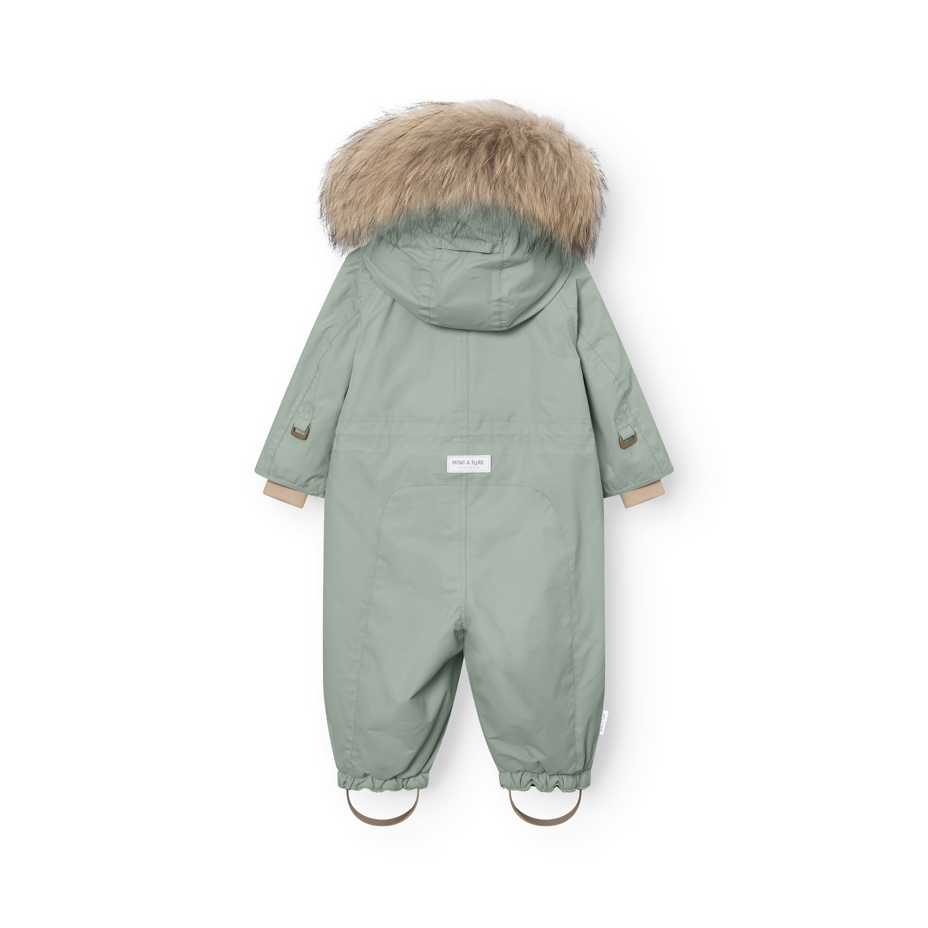 Rear view of MATWISTI fleece lined snowsuit fur in sage green with genuine fur-trimmed hood, MINI A TURE label at the lower back, elasticated ankle cuffs with adjustable foot straps, and reflective details on the sleeves.