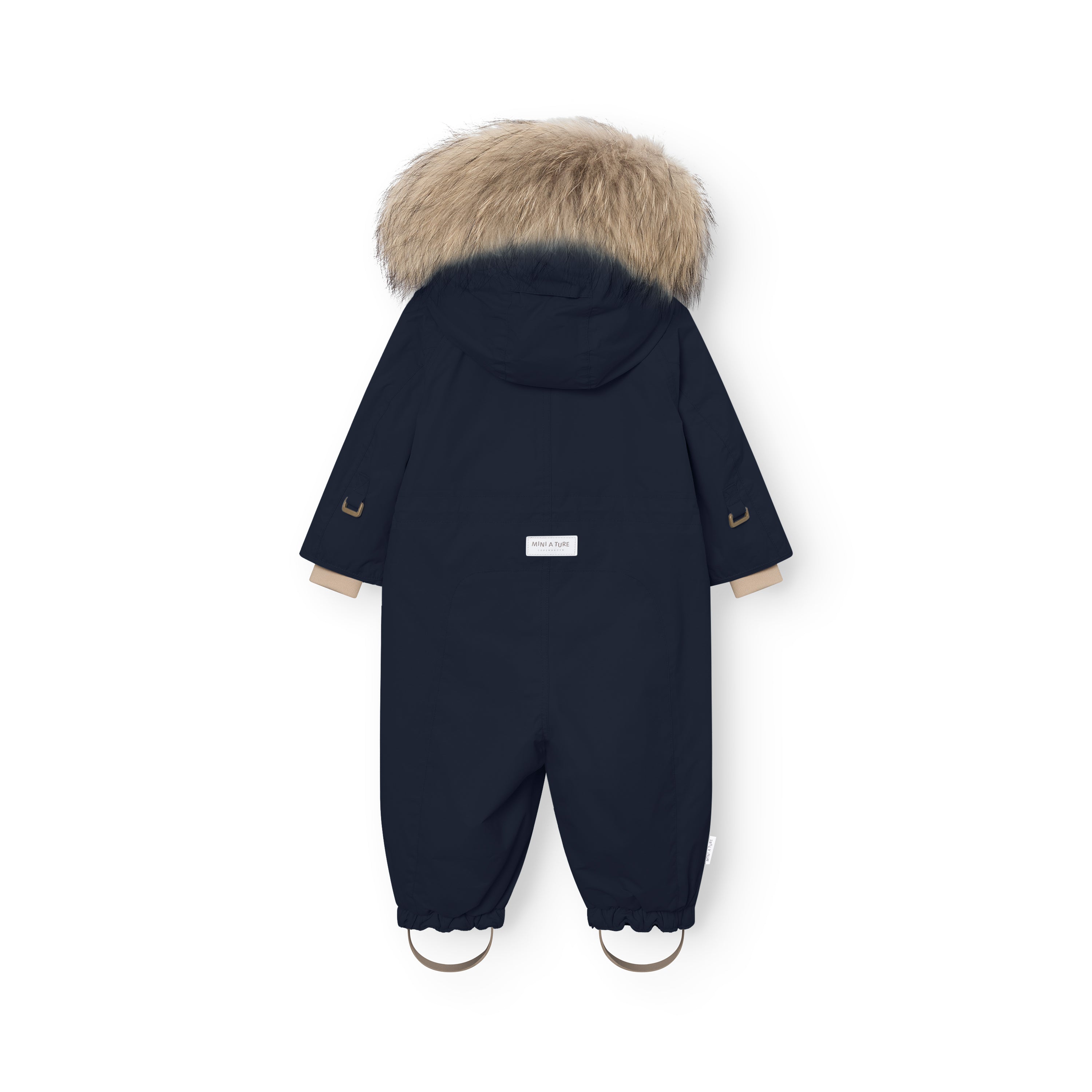 Rear view of MATWISTI fleece lined snowsuit fur in navy blue with genuine fur-trimmed hood, MINI A TURE label at the lower back, elasticated ankle cuffs with adjustable foot straps, and reflective details on the sleeves.